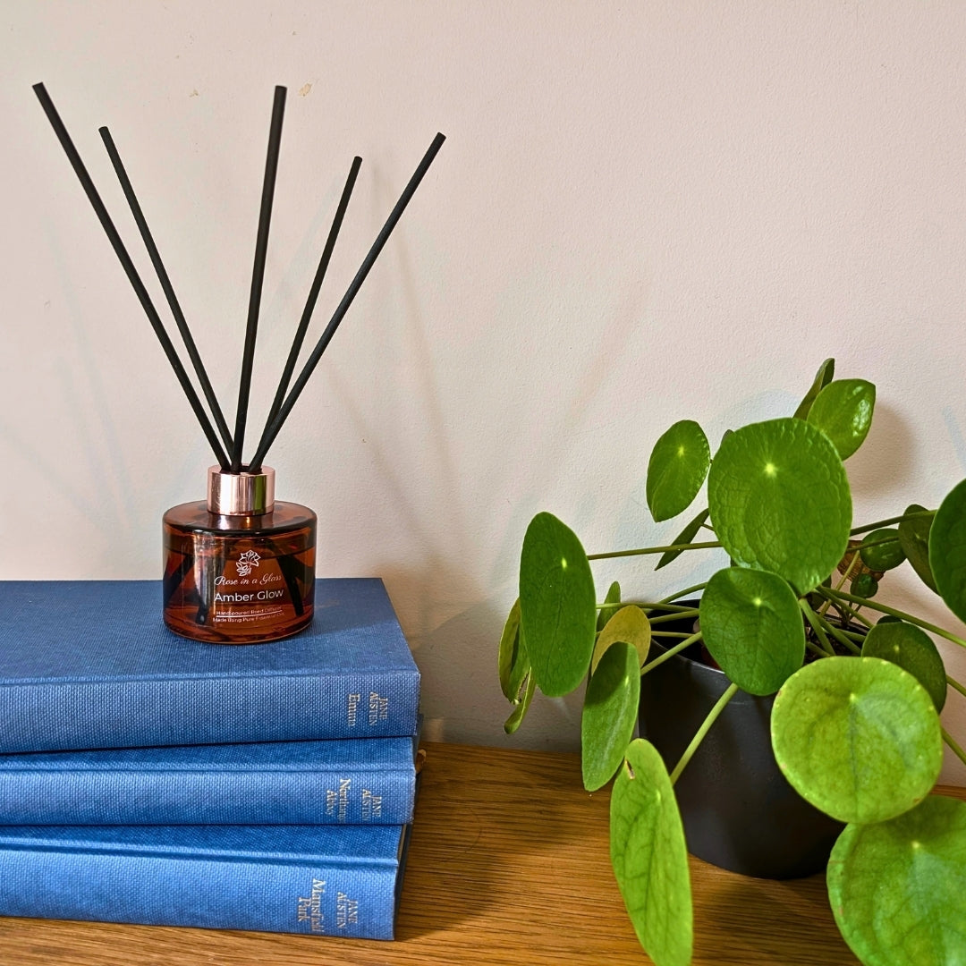 Amber Glow Aromatherapy reed diffuser on classic literature books for a tranquil home environment