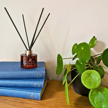 Meadow Bloom Aromatherapy reed diffuser on classic literature books for a tranquil home environment