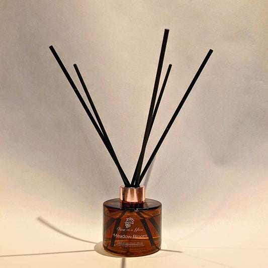Botanical Meadow Bloom reed diffuser with black fibre reeds for continuous aromatherapy wellness and busy mind sensory support