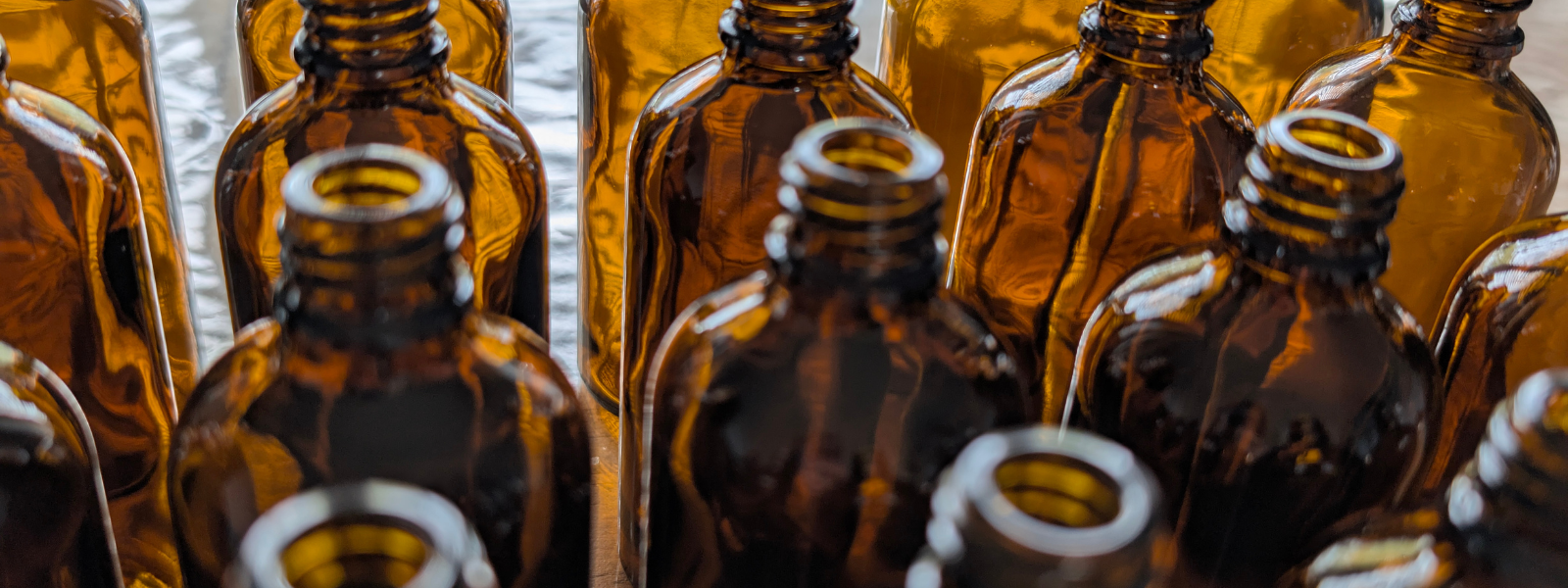 Apothecary glass bottles in Rose in a Glass Hampshire studio.